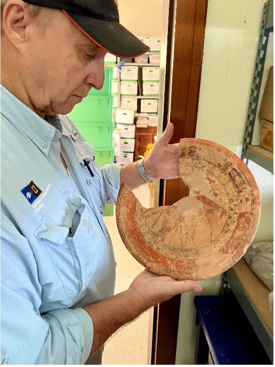 Dr. Hansen analyzes a Pre-Columbian, partially reconstructed ceramic plate.